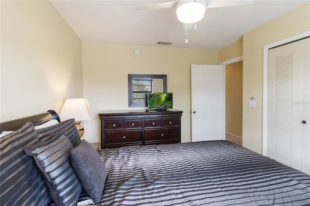 bedroom with ceiling fan, a closet, and a textured ceiling