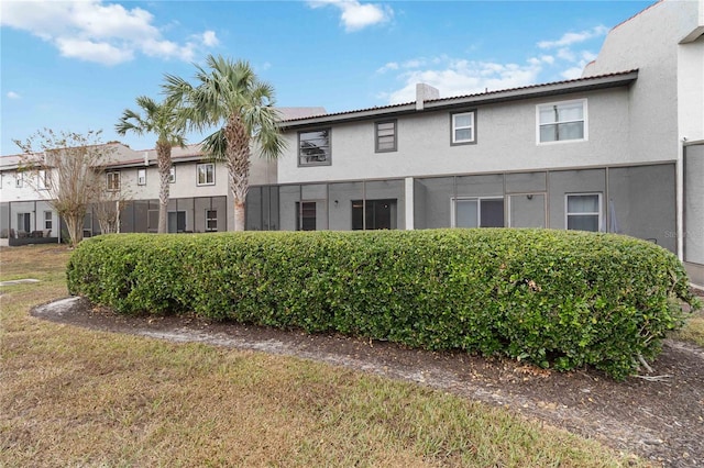 2007 Disney Mgm Studio Ct, Kissimmee, FL 34746 - rear view of house with stucco siding and a lawn