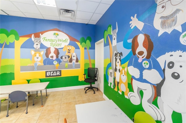 playroom featuring tile patterned flooring and a drop ceiling