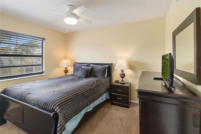 bedroom featuring carpet, ceiling fan, and a textured ceiling