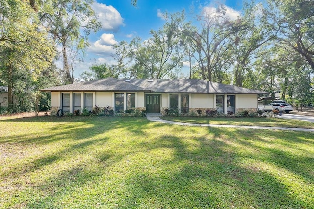 ranch-style house with stucco siding and a front yard