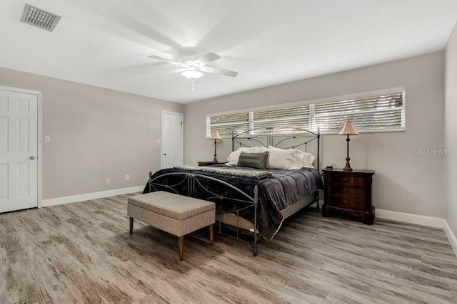 bedroom featuring visible vents, light wood-style flooring, and multiple windows