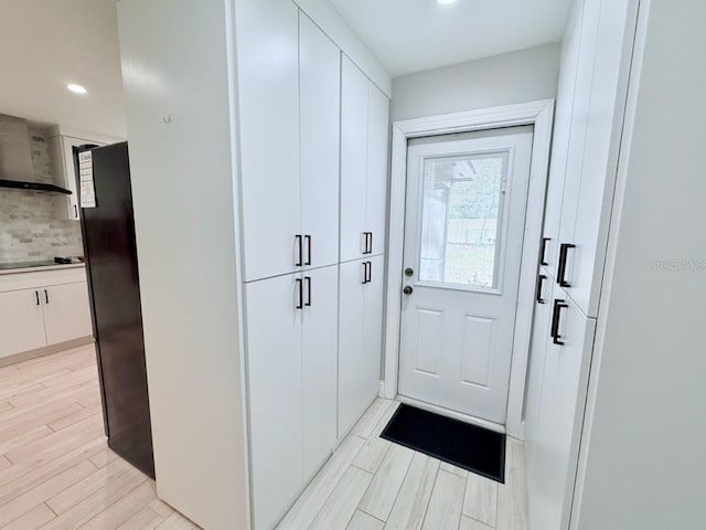 doorway with recessed lighting and light wood finished floors