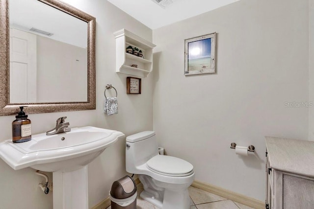 bathroom with toilet, visible vents, baseboards, and tile patterned floors