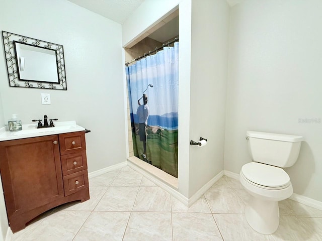 bathroom featuring curtained shower, toilet, vanity, baseboards, and tile patterned floors