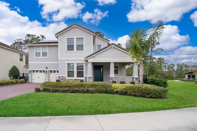 craftsman-style house with a front yard, covered porch, a garage, and solar panels