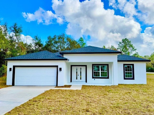 view of front of property with a garage and a front lawn