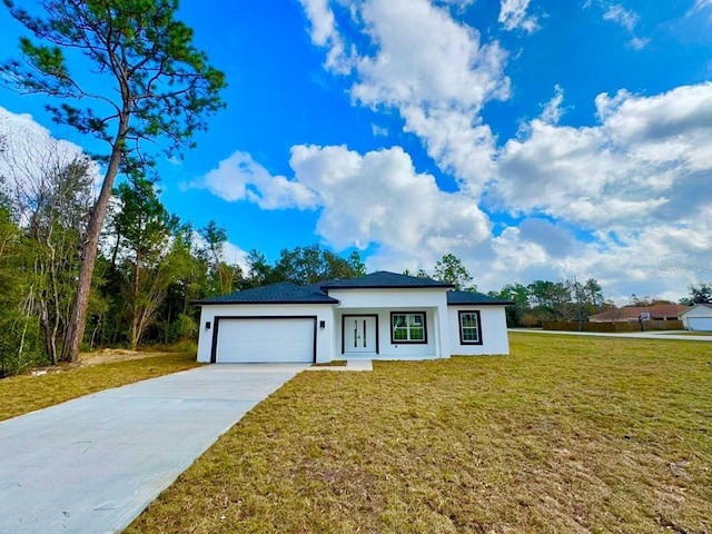 view of front of property with a front yard and a garage