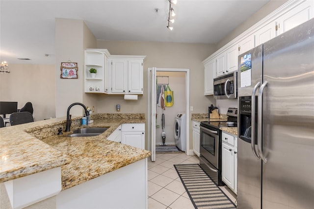 kitchen with kitchen peninsula, sink, white cabinets, and stainless steel appliances