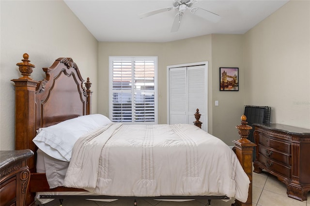 bedroom with ceiling fan, light tile patterned flooring, and a closet