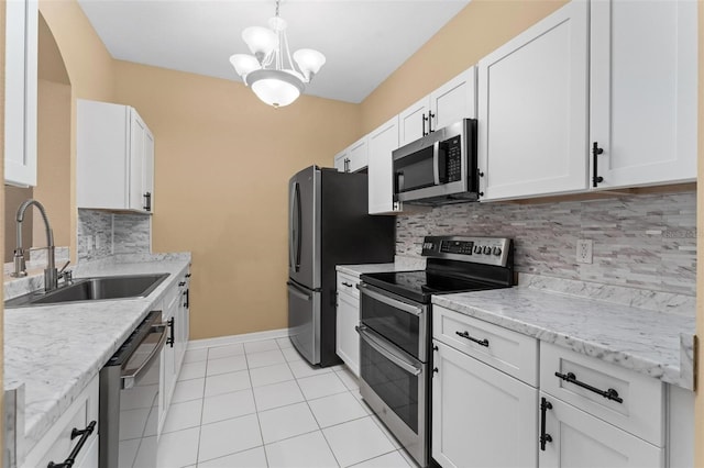 kitchen with sink, white cabinets, stainless steel appliances, and light tile patterned floors