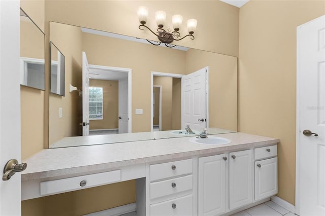 bathroom with tile patterned flooring, vanity, and a notable chandelier