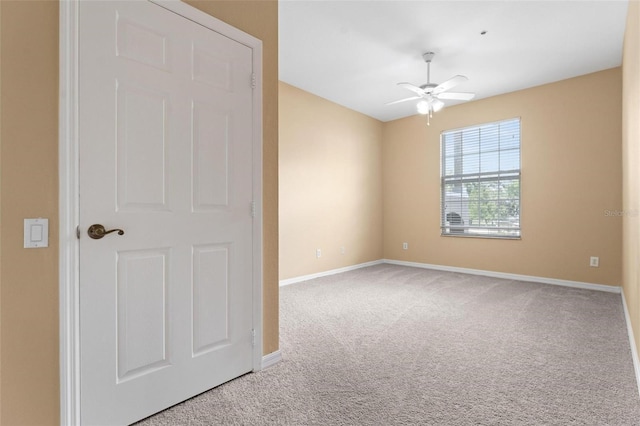 unfurnished room with carpet flooring and ceiling fan