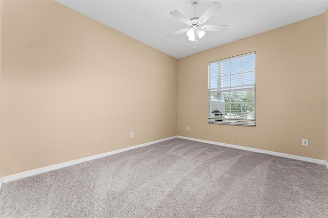 spare room featuring ceiling fan and carpet floors