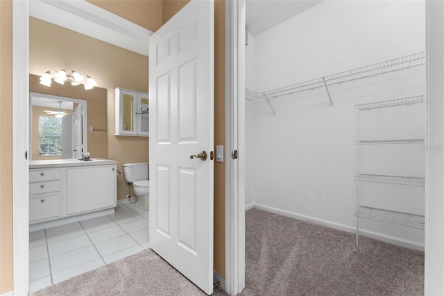 bathroom featuring tile patterned floors, ceiling fan, vanity, and toilet