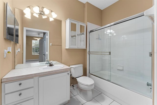 full bathroom featuring ceiling fan, tile patterned flooring, toilet, shower / bath combination with glass door, and vanity