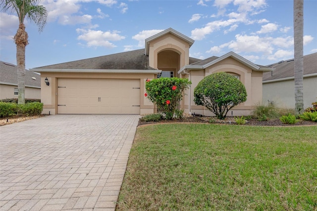 view of front of property featuring a front yard and a garage