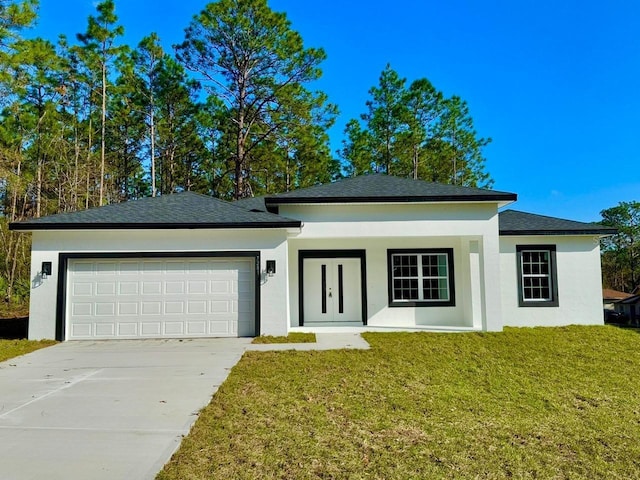 view of front of house featuring a front yard and a garage