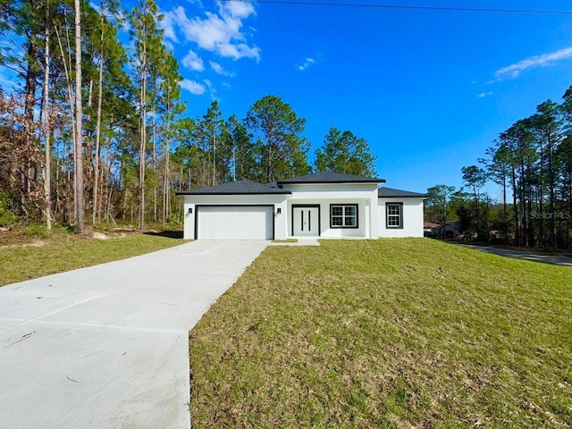 view of front facade with a front yard and a garage