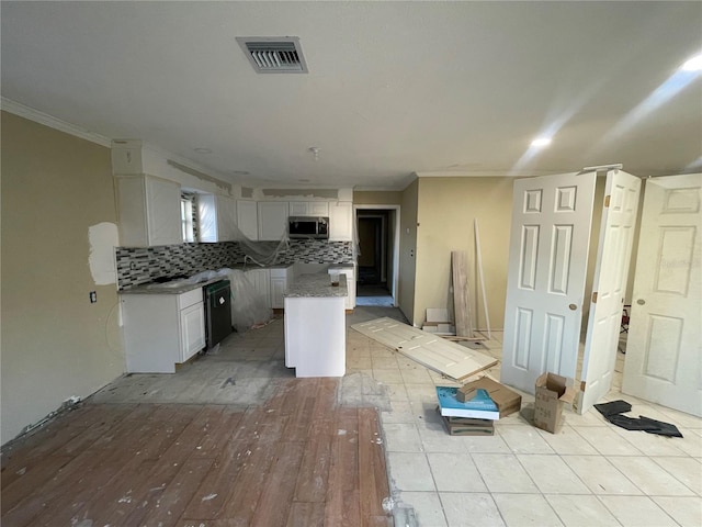 kitchen featuring white cabinets, dishwasher, crown molding, and tasteful backsplash