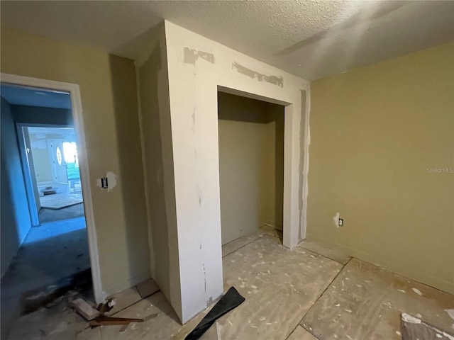 corridor with a textured ceiling