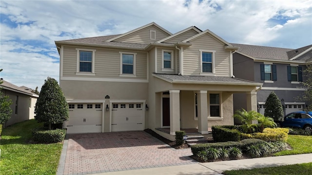 view of front of house featuring a porch and a garage