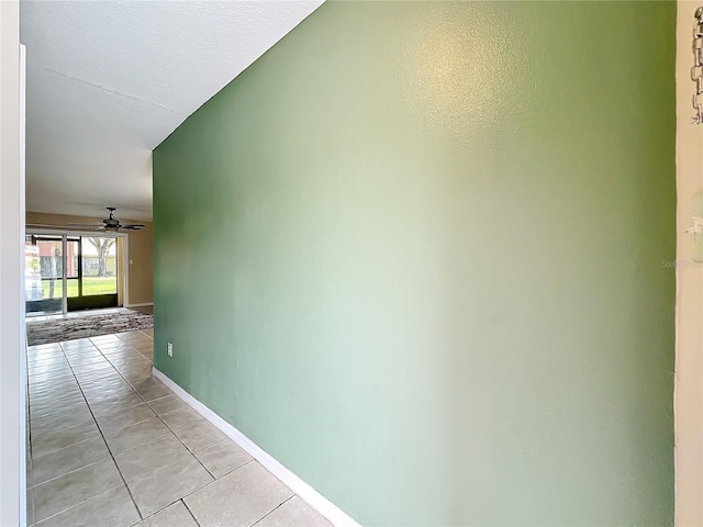 hall with light tile patterned floors