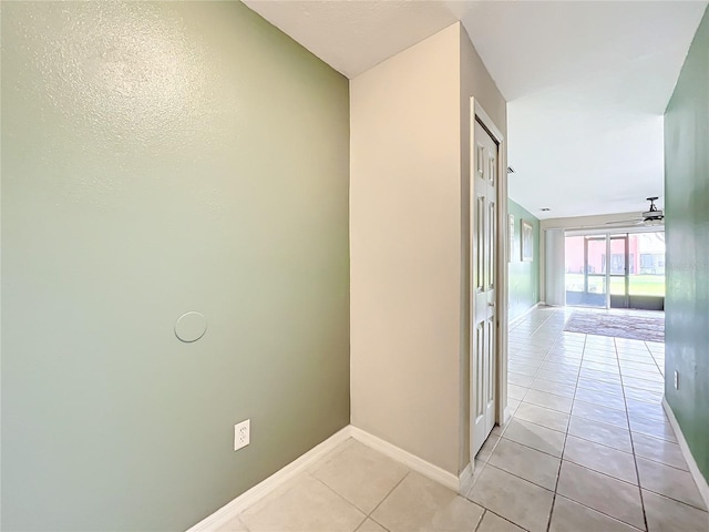 hall featuring light tile patterned floors