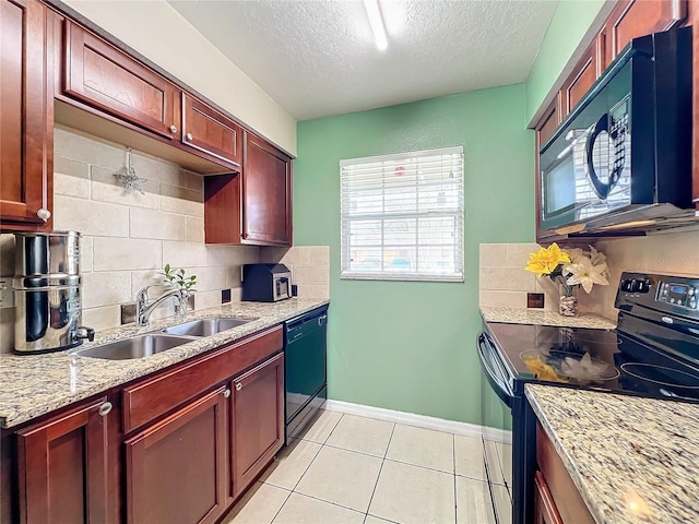 kitchen featuring backsplash, black appliances, sink, light tile patterned floors, and light stone counters