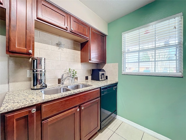 kitchen with light stone countertops, sink, black dishwasher, tasteful backsplash, and light tile patterned floors