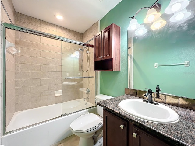 full bathroom featuring toilet, combined bath / shower with glass door, and vanity