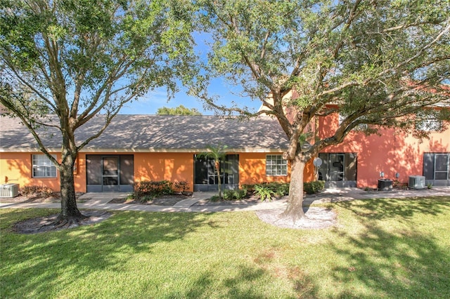 single story home featuring central AC unit and a front lawn