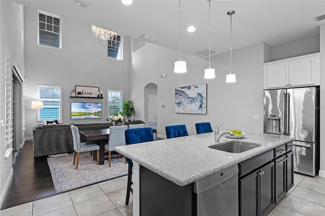 kitchen featuring a sink, arched walkways, visible vents, and stainless steel appliances