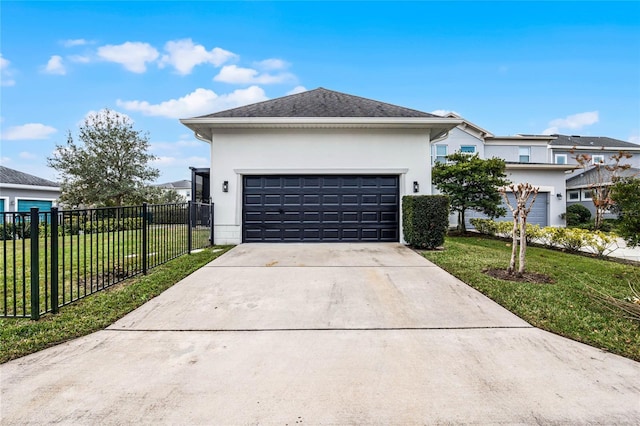 view of front of home with fence, a front yard, stucco siding, a garage, and driveway