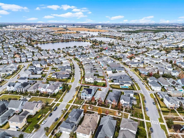 birds eye view of property with a water view and a residential view