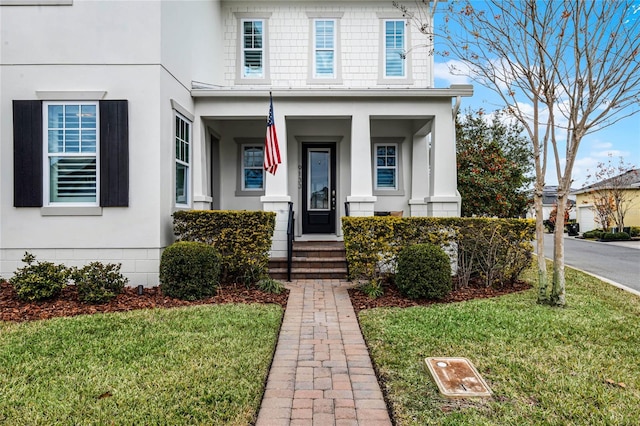 view of front of home featuring stucco siding and a front yard