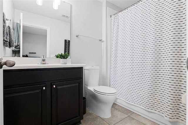 full bathroom featuring visible vents, toilet, a shower with shower curtain, tile patterned floors, and vanity