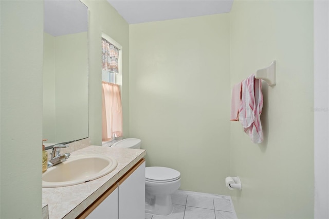 bathroom with tile patterned flooring, vanity, and toilet