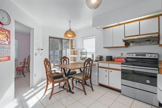 kitchen with white cabinets, stainless steel range with electric cooktop, and decorative light fixtures