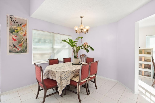 dining room featuring light tile patterned flooring and a chandelier