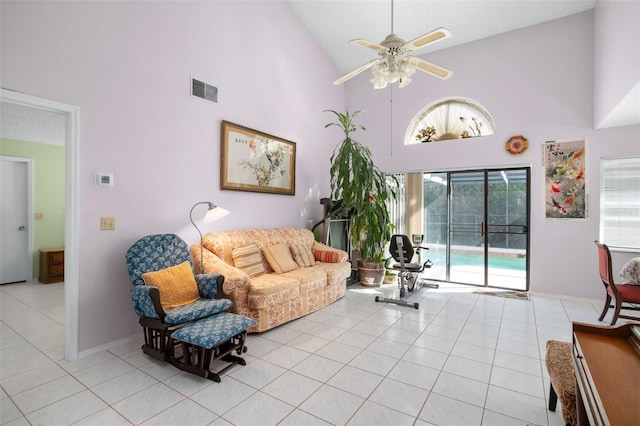 living room with ceiling fan, high vaulted ceiling, and light tile patterned floors