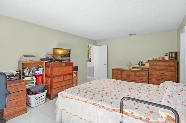 tiled bedroom with a textured ceiling