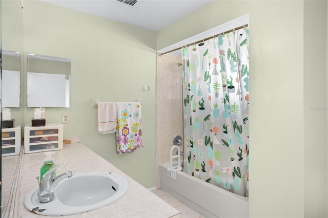 bathroom with tile patterned flooring, vanity, and shower / tub combo