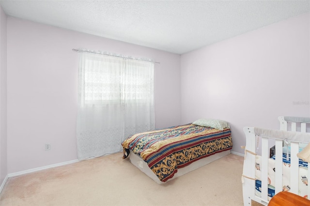 bedroom featuring carpet floors and a textured ceiling