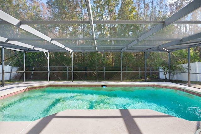 view of pool featuring glass enclosure