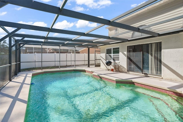 view of swimming pool with a lanai and a patio