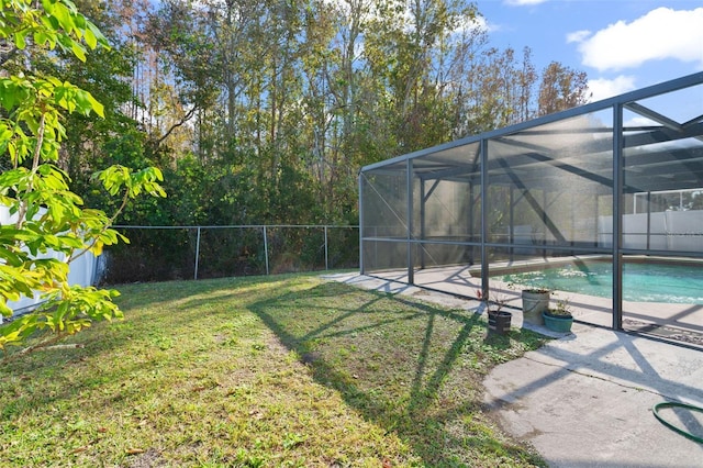 view of yard featuring a patio, a fenced in pool, and a lanai