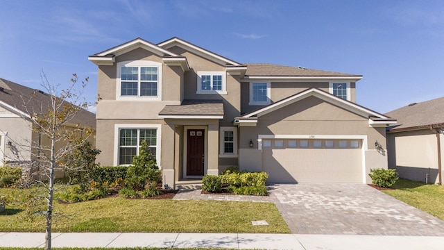 view of front of house featuring a front yard and a garage