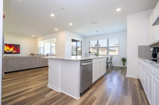 kitchen with dark hardwood / wood-style flooring, white cabinets, pendant lighting, a center island with sink, and dishwasher