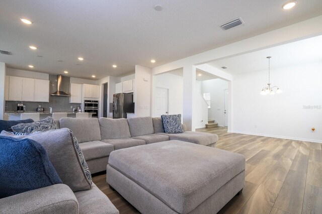 living room featuring light hardwood / wood-style flooring and a chandelier